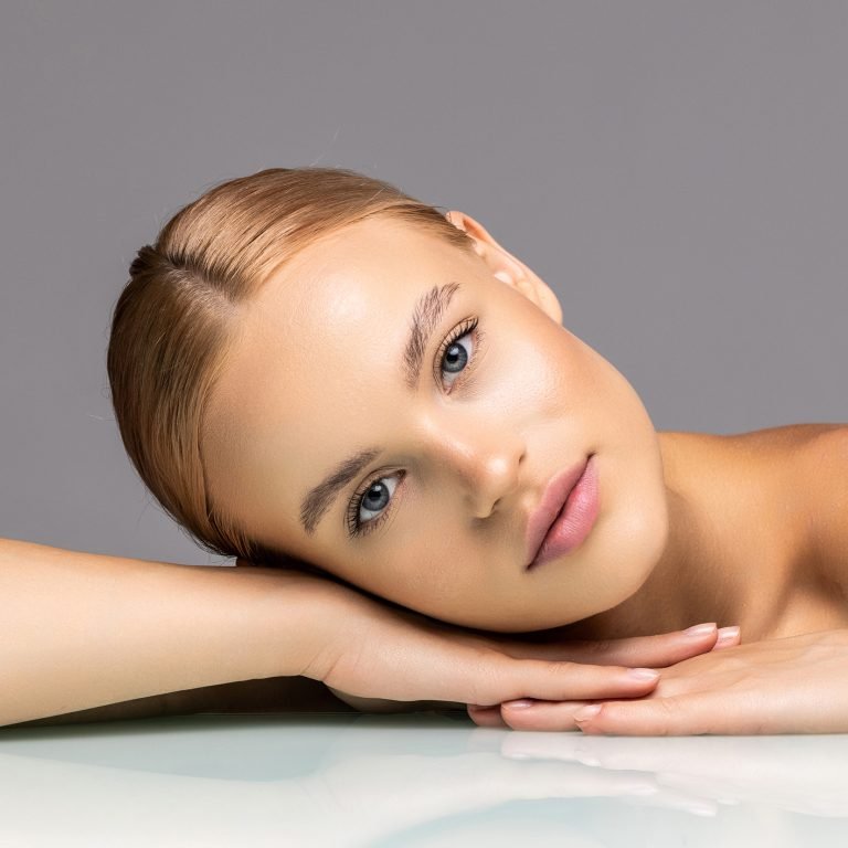 Healthy skin woman beautiful face close up over gray background